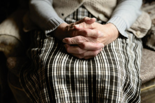 caregiver tidying home for senior light housekeeping